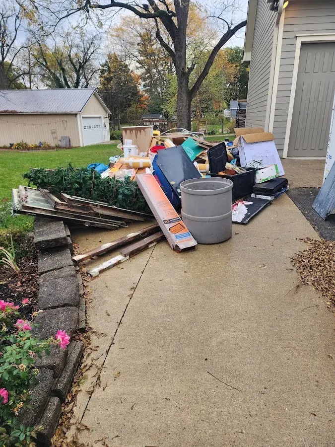 Dumpster being loaded with debris for 12 Yard Dumpster Rental in Brenham